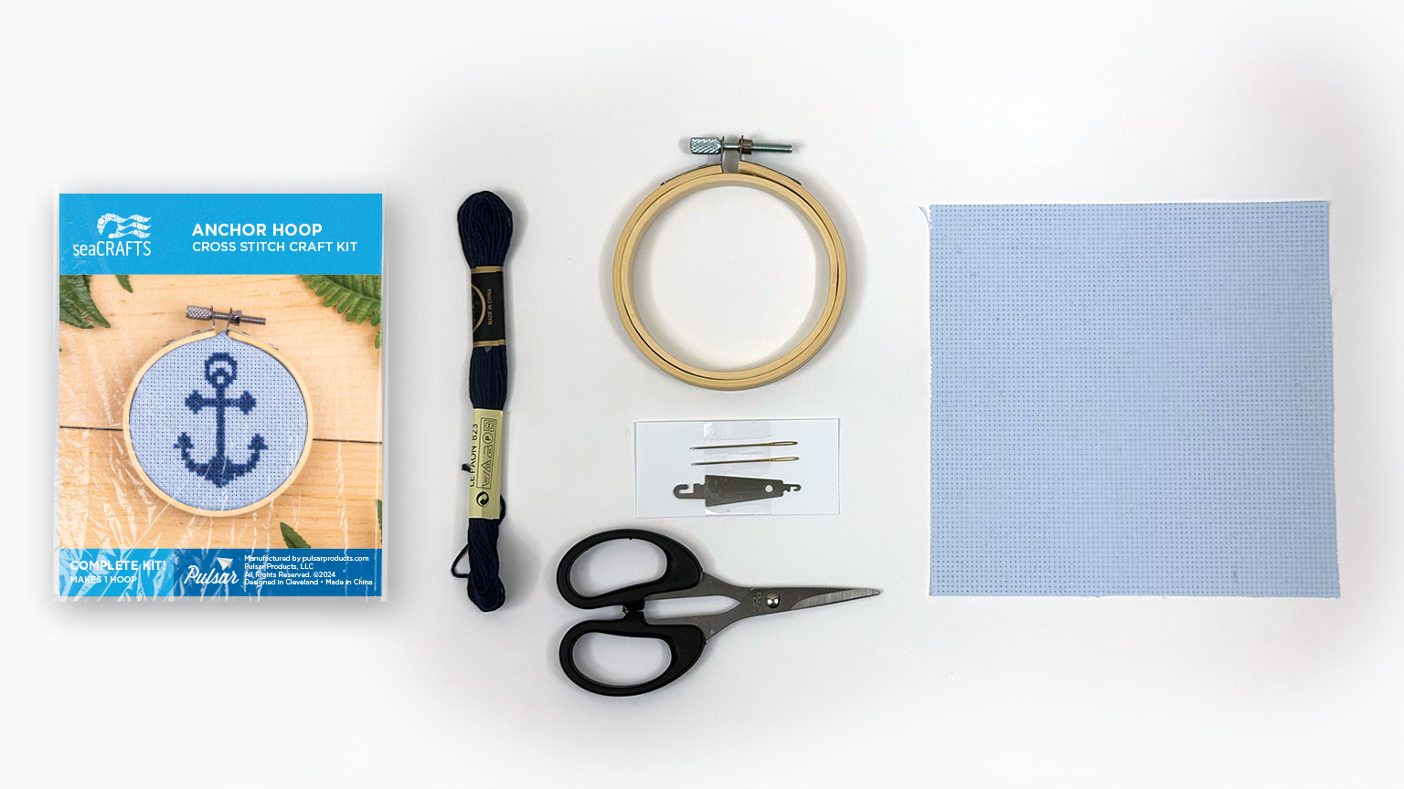 Craft kit packaging and materials laid flat on a white background